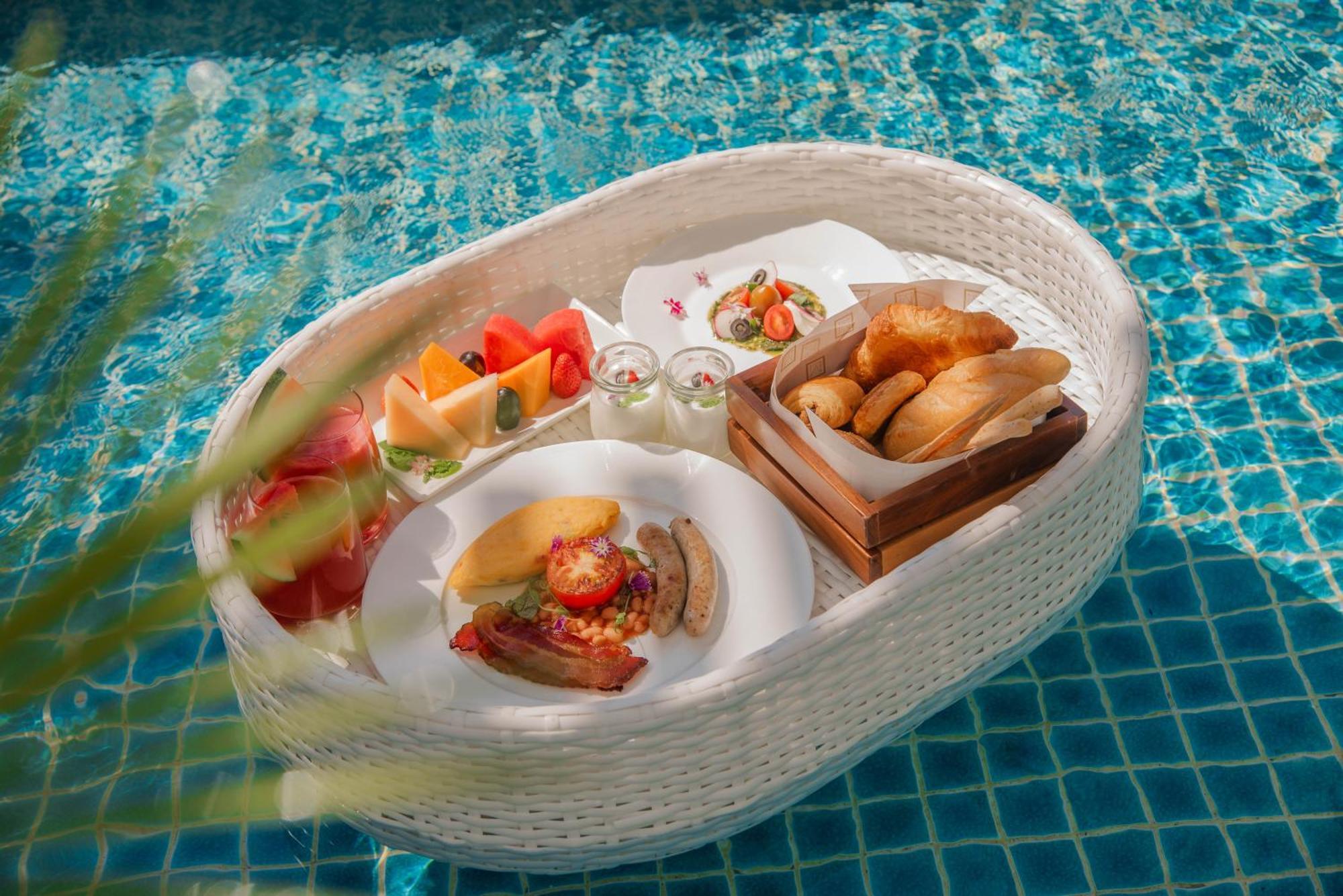 Mai House Saigon Hotel Ho Chi Minh-staden Exteriör bild A floating breakfast at a resort in Bali, Indonesia